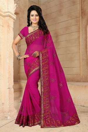 If You Have And Eye For Embroidery Than Grab This Very Beautiful Designer Saree In Rani Pink Color With Heavy Kashmiri Embroidery And Stone Work. This Pretty Saree And Blouse Are Fabricated On Georgette. Its Fabric Is Light Weight And Its Lovely Embroidery Gives An Attractive Look Over All. 