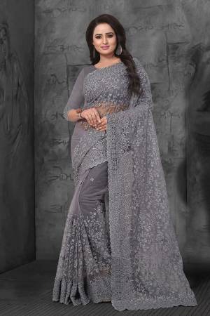 Flaunt Your Rich And Elegant Taste Wearing This Heavy Designer Saree In All Over Grey Color. This Heavy Tone To Tone Embroidered Saree And Blouse are Fabricated On Net. Its Fabric Is Light In Weight And Easy To Carry Throughout The Gala. 