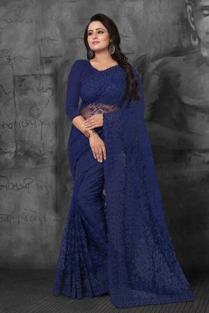 Enhance Your Personality In This Heavy And Attractive Looking Designer Saree In Navy Blue Color. This Saree And Blouse are Net Based Beautified With Tone To Tone Resham Embroidery And Ceramic Stone Work. 
