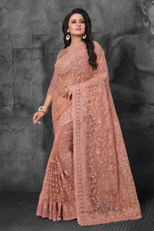 Get Ready For The Upcoming Wedding Season With This Heavy Designer Saree In Peach Color Which Is Most Trending Color OF The Season. This Saree And Blouse Are Fabricated On Net Beautified With Heavy Tone To Tone Resham and Ceramic Stone Work.