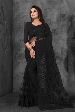 Here Is A Very Beautiful Heavy Embroidered Designer Saree In Black Color. This Saree And Blouse are Fabricated On Net Beautified With Tone To Tone Heavy Resham Embroidery With Ceramic Stone Work. Its  Embroidery Gives Heavy And Subtle Look To Your Personality Both At The Same Time. 