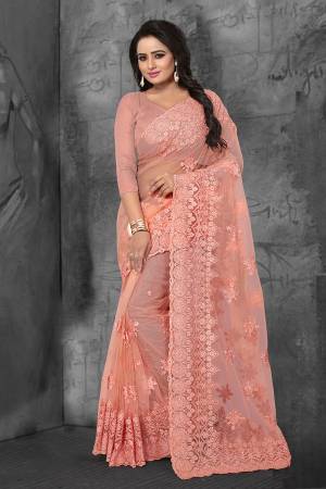 Get Ready For The Upcoming Wedding Season With This Heavy Designer Saree In Peach Color Which Is Most Trending Color OF The Season. This Saree And Blouse Are Fabricated On Net Beautified With Heavy Tone To Tone Resham and Ceramic Stone Work.