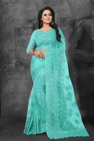 Bright And Appealing Color Is Here With This Heavy Designer Saree In Aqua Blue Color. This Saree and Blouse are Fabricated On Net Beautified With Tone To Tone Resham Embroidery And Ceramic Stone Work. It Is Easy To Drape And Carry Throughout The Gala.
