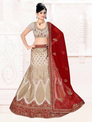 Flaunt Your Rich And Elegant Taste With Some Subtle Color Pallet In Your Bridal Wear. Grab This Heavy Designer Lehenga Choli In Grey Color Paired With Maroon Colored Dupatta. Its Blouse Are Lehenga are Satin Silk Based Paired With Net Fabricated Dupatta. 