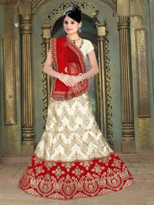 Flaunt Your Rich And Elegant Taste With Some Subtle Color Pallet In Your Bridal Wear. Grab This Heavy Designer Lehenga Choli In Off-White Color Paired With Maroon Colored Dupatta. Its Blouse Are Lehenga are Satin Silk Based Paired With Net Fabricated Dupatta. 