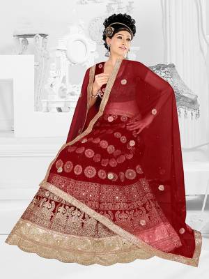 Here Is A Very Beautiful Heavy Designer Bridal Lehenga Choli In All Over Maroon. Its Blouse And Lehenga Are Fabricated On Satin Silk Paired With Net Fabricated Dupatta. It Is Beautified With Heavy Embroidery Giving It An Attractive Look. 