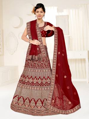 Here Is A Very Beautiful Heavy Designer Bridal Lehenga Choli In All Over Dark Maroon Color. Its Blouse And Lehenga Are Fabricated On Satin Silk Paired With Net Fabricated Dupatta. It Is Beautified With Heavy Embroidery Giving It An Attractive Look. 