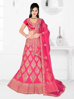 Here Is A Very Beautiful Heavy Designer Bridal Lehenga Choli In All Over Fuschia Pink. Its Blouse And Lehenga Are Fabricated On Satin Silk Paired With Net Fabricated Dupatta. It Is Beautified With Heavy Embroidery Giving It An Attractive Look. 