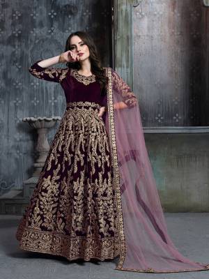 Grab This Very Beautiful Heavy Designer Floor Length Suit In Wine Color Paired With Contrasting Pink Colored Dupatta. Its Heavy Embroidered Top Is Fabricated On Velvet Paired With Santoon Bottom And Net Fabricated Dupatta. Buy Now.