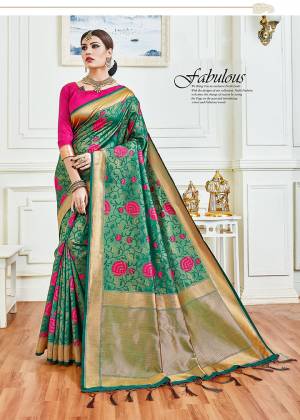 For An Attractive Festive Look, Grab This Designer Silk Based Saree In Green Color Paired With Contrasting Dark Pink Colored Blouse. This Saree And Blouse silk Based Beautified With Intricate Weave. 