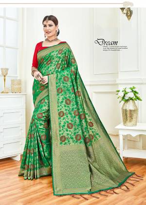 For An Attractive Festive Look, Grab This Designer Silk Based Saree In Green Color Paired With Contrasting Red Colored Blouse. This Saree And Blouse silk Based Beautified With Intricate Weave. 