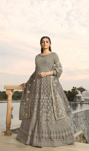 Look The Most Prettiest Of All Wearing This Designer Floor Length Suit In All Over Grey Color. Its Heavy Embroidered Top Is Fabricated On Georgette Paired With Santoon Bottom And Net Fabricated Dupatta. Its Fabrics And Embroidery are light Weight And Ensures Superb Comfort All Day Long. 