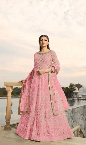 Look The Most Prettiest Of All Wearing This Designer Floor Length Suit In All Over Baby Pink Color. Its Heavy Embroidered Top Is Fabricated On Georgette Paired With Santoon Bottom And Net Fabricated Dupatta. Its Fabrics And Embroidery are light Weight And Ensures Superb Comfort All Day Long. 