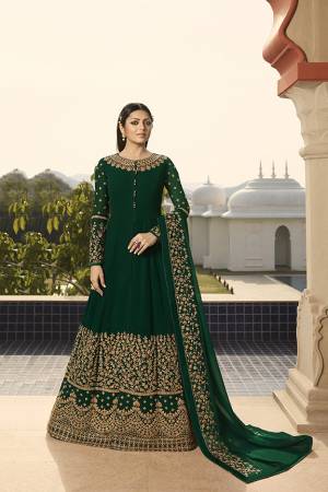Enhance Your Personality Wearing This Heavy Designer Floor Length Suit In All Over Dark Green Color. This Rich Pattern And Heavy Embroidery Will Give You Look Like Never Before. Its Heavy Embroidered Top And Dupatta Are Fabricated On Georgette Paired With Santoon Fabricated Bottom. 