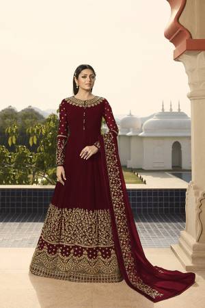 Enhance Your Personality Wearing This Heavy Designer Floor Length Suit In All Over Maroon Color. This Rich Pattern And Heavy Embroidery Will Give You Look Like Never Before. Its Heavy Embroidered Top And Dupatta Are Fabricated On Georgette Paired With Santoon Fabricated Bottom. 