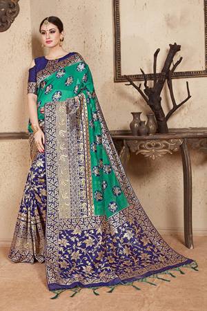 Celebrate This Festive Season Wearing This Designer Silk Based Saree In Sea Green And Navy Blue Color Paired With Navy Blue Colored Blouse. This Saree And Blouse Are Fabricated On Soft Art Silk Beautified With Weave All Over. 