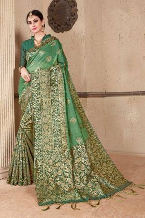 Celebrate This Festive Season Wearing This Designer Silk Based Saree In Green Color Paired With Green Colored Blouse. This Saree And Blouse Are Fabricated On Soft Art Silk Beautified With Weave All Over. 