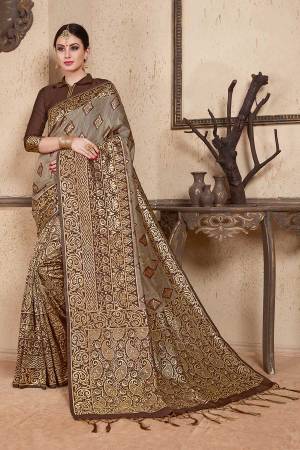 Celebrate This Festive Season Wearing This Designer Silk Based Saree In Grey & Brown Color Paired With Brown Colored Blouse. This Saree And Blouse Are Fabricated On Soft Art Silk Beautified With Weave All Over. 