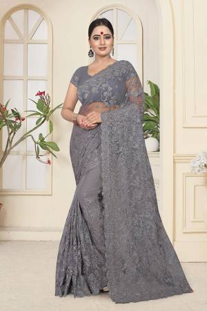 Flaunt Your Rich And Elegant Taste Wearing This Heavy Designer Saree In All Over Grey Color. This Heavy Tone To Tone Embroidered Saree And Blouse are Fabricated On Net. Its Fabric Is Light In Weight And Easy To Carry Throughout The Gala