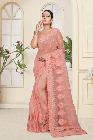 Get Ready For The Upcoming Wedding Season With This Heavy Designer Saree In Dark Peach Color Which Is Most Trending Color OF The Season. This Saree And Blouse Are Fabricated On Net Beautified With Heavy Tone To Tone Resham and Ceramic Stone Work.