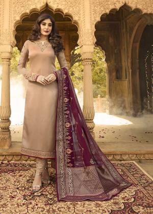 Flaunt Your Rich And Elegant Taste Wearing This Designer Straight Suit In Beige Color Paired With Contrasting Maroon Colored Dupatta. Its Pretty Embroidered Top Is Fabricated On Satin Georgette Paired With Santoon Bottom And A Very Fancy Georgette Dupatta With Broad Borders Or Jacquard Silk. 