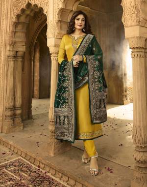 Celebrate This Festive Season Wearing This Designer Embroidered Straight Suit In Musturd Yellow Color Paired With Contrasting Dark Green Colored Dupatta. Its Top IS Fabricated On Satin Georgette Paired With Santoon Bottom And Georgette & Jacquard Silk Dupatta. 