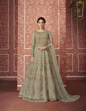 Catch All The Limelight This Wedding Season Wearing This Heavy Designer Floor Length Suit In Pastel Green Colored Top, Bottom And Dupatta. Its Heavy Embroidered Top Is Fabricated On Net Paired With Satin Bottom and Net Fabricated Dupatta. Its Pretty Embroidery Gives A Heavy And Subtle Look Both At The Same Time. Buy Now.