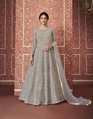 Catch All The Limelight This Wedding Season Wearing This Heavy Designer Floor Length Suit In Grey Colored Top, Bottom And Dupatta. Its Heavy Embroidered Top Is Fabricated On Net Paired With Satin Bottom and Net Fabricated Dupatta. Its Pretty Embroidery Gives A Heavy And Subtle Look Both At The Same Time. Buy Now.
