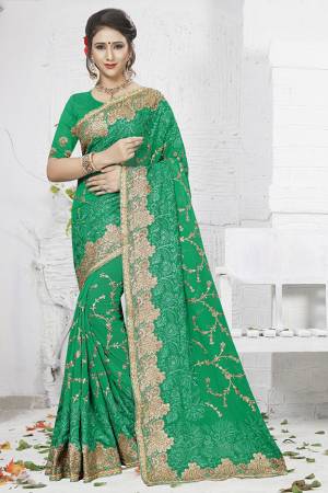 Celebrate This Festive And Wedding Season Wearing This Heavy Designer Saree In Green Color. This Saree Is Georgette Based With Heavy Embroidery Work Paired With Art Silk Fabricated Blouse. 