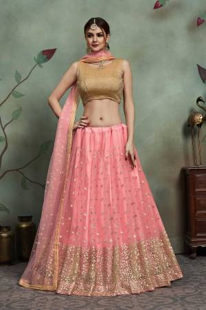 Look Pretty In This Beautiful Designer Lehenga Choli In Golden Colored Blouse Paired With Pink Colored Lehenga And Dupatta. Its Blouse Is Lycra Based Paired With Soft Net Fabricated Lehenga And Dupatta. It Is Beautified With Attractive Sequence Work. 