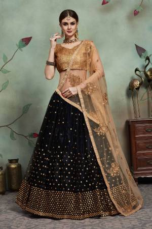 For A Bold And Beautiful Look, Grab This Very Beautiful Designer Lehenga Choli In Golden Colored Blouse Paired With Black Colored Lehenga And Beige Colored Dupatta. Its Sequence Blouse Is Fabricated On Art Silk Paired With Soft Net Fabricated Lehenga And Dupatta. Buy Now.