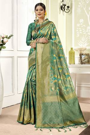 Add This Very Pretty Silk Based Saree To Your Wardrobe In Sea Green Color. This Saree Is Fabricated On Banarasi Art Silk Paired With Art Silk Fabricated Blouse. It Is Beautified With Floral Weave All Over It