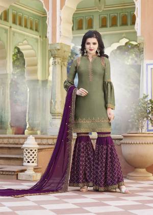 Grab This Very Pretty Heavy Designer Sharara Suit In Olive Green Colored Top Paired With Magenta Pink Colored Bottom and Dupatta. Its Top And Bottom Are Satin Based Paired With Georgette Fabricated Dupatta. All Three Piece Are Beautified With Heavy Embroidery. 