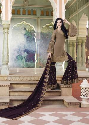 New Color Pallete Is Here With This Designer Sharara Suit In Sand Grey Colored Top Paired With Contrasting Wine Colored Bottom And Dupatta. Its Heavy Embroidered Top And Bottom Are Fabricated On Satin Paired With Embroidered Georgette Fabricated Dupatta.
