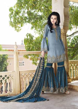 Go With The Pretty Shades Of Blue With This Heavy Designer Sharara Suit In Light Blue Colored Top Paired With Blue Colored Bottom And Dupatta. Its Top And Bottom are Satin Based Paired With Georgette Fabricated Dupatta. Its Top , bottom And Dupatta Are Beautified With Heavy Attractive Embroidery. 