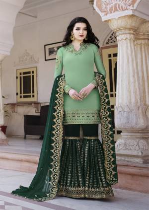 Go With The Pretty Shades Of Blue With This Heavy Designer Sharara Suit In Light Green Colored Top Paired With Dark Green Colored Bottom And Dupatta. Its Top And Bottom are Satin Based Paired With Georgette Fabricated Dupatta. Its Top , bottom And Dupatta Are Beautified With Heavy Attractive Embroidery. 