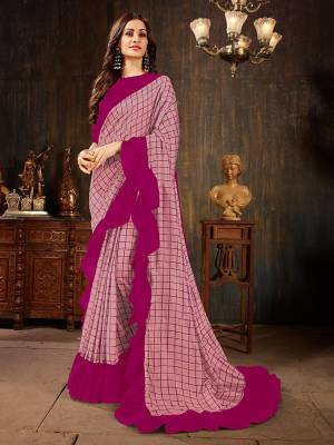 Celebrate This Festive Season With This Treding Ruffle Saree In Light Pink Color Paired With Dark Pink Colored Blouse. This Saree And Blouse Are Silk Based Beautified With Checks Prints And Ruffle Border. Buy Now.
