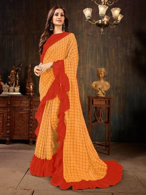 Celebrate This Festive Season With This Treding Ruffle Saree In Light Orange Color Paired With Orange Colored Blouse. This Saree And Blouse Are Silk Based Beautified With Checks Prints And Ruffle Border. Buy Now.