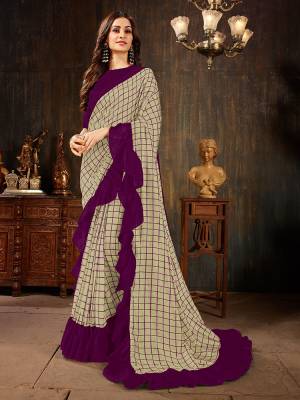 Celebrate This Festive Season With This Treding Ruffle Saree In Grey Color Paired With Purple Colored Blouse. This Saree And Blouse Are Silk Based Beautified With Checks Prints And Ruffle Border. Buy Now.