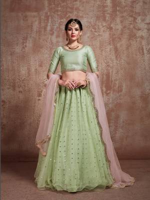 Beat The Heat This Summer With Pastel Traditional Outifts. This Pretty Lehenga Choli Is In Pastel Green Color Paired With Contrasting Pastel Pink Colored Dupatta. Its Pretty Blouse Is Fabricated On Art Silk Paired With Net Fabricated Lehenga And Dupatta. 