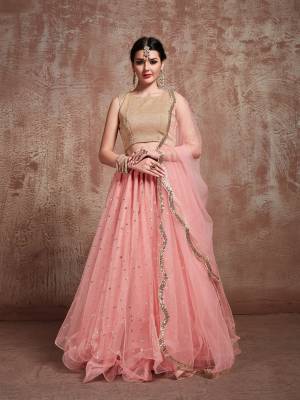 Grab This Very Pretty Designer Lehenga Choli In Beige Colored Blouse Paired With Baby Pink Colored Lehenga And Dupatta. This Blouse Is Fabricated On Lycra Paired With Net Fabricated Lehenga And Dupatta. Its Pretty Color And minimal Embroidery Will Give A Pretty Subtle Look To Your Personality. 