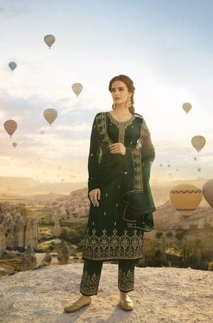 Get Ready For The Upcoming Festive And Wedding Season Wearing This Heavy Designer Straight Suit In All Over Dark Green Color. Its Top Is Fabricated On Satin Georgette Paired With Santoon Bottom And Georgette Fabricated Dupatta. Its Top, Bottom And Dupatta Are Beautified With Heavy Embroidery Giving It An Attractive Look. 