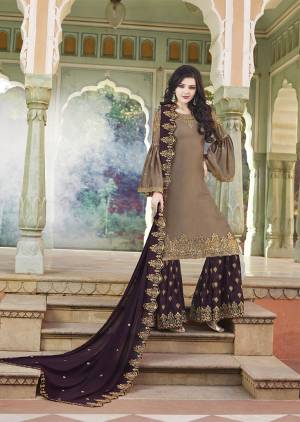 New Color Pallete Is Here With This Designer Plazzo Suit In Sand Grey Colored Top Paired With Contrasting Wine Colored Bottom And Dupatta. Its Heavy Embroidered Top And Bottom Are Fabricated On Satin Paired With Embroidered Georgette Fabricated Dupatta.