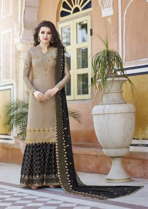 Flaunt Your Rich And Elegant Taste Wearing This Heavy Designer Plazzo Suit In Beige And Black Color Which Is Trending This Season. Its Heavy Embroidered Satin based Top And Bottom Are Paired With Georgette Based Dupatta. Buy This Designer Piece Now.