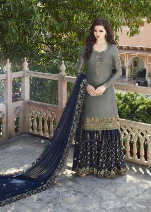 Flaunt Your Rich And Elegant Taste Wearing This Heavy Designer Plazzo Suit In Grey And Navy Blue Color Which Is Trending This Season. Its Heavy Embroidered Satin based Top And Bottom Are Paired With Georgette Based Dupatta. Buy This Designer Piece Now.