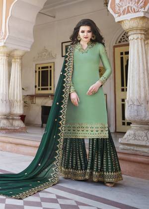 Go With The Pretty Shades Of Blue With This Heavy Designer Plazzo Suit In Light Green Colored Top Paired With Dark Green Colored Bottom And Dupatta. Its Top And Bottom are Satin Based Paired With Georgette Fabricated Dupatta. Its Top , bottom And Dupatta Are Beautified With Heavy Attractive Embroidery. 