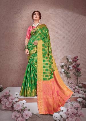 Celebrate This Festive Season With Beauty And Comfort Wearing This Designer Saree In Green Color Paired With Contrasting Pink Colored Blouse. This Saree And Blouse Are Fabricated On Banarasi Art Silk Beautified With Weave All Over. It Is Light Weight And Easy To Drape. 