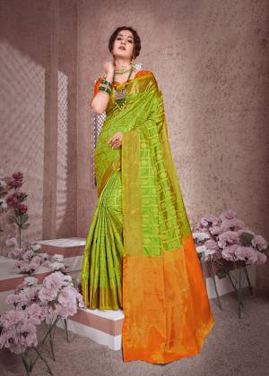Catch All The Limelight At The Next Function You Attend Wearing This Silk Based Saree In Parrot Green Color Paired With Contrasting Orange Colored Blouse. Its Rich Banarasi Art Silk Fabric Will Give A Royal Look To Your Personality. 