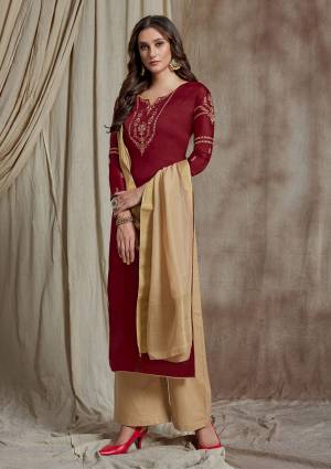 Flaunt Your Rich And Elegant Taste Wearing This Designer Straight Suit In Maroon Colored Top Paired With Contrasting Cream Colored Bottom And Dupatta. Its Pretty Embroidered Top Is Fabricated On Soft Silk Paired With Satin Bottom And Banarasi Art Silk Dupatta. 