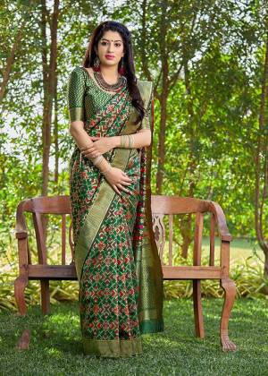 Celebrate This Festive Season In A Traditional Look Wearing This Designer Silk Based Saree In Dark Green Color. This Saree And Blouse Are Fabricated On Banarasi Art Silk Beautified With Weave All Over. 